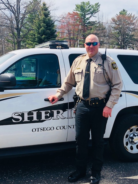 Keith Sterly poses with Sheriff Car